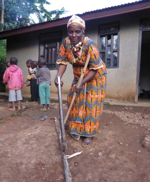 Madame Mbambu chopping wood